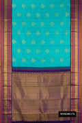 Peacock Blue Dual Tone Kanchipuram Silk Saree with Zari Butta on the body and Fancy Border.  displayed on a mannequin