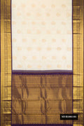 Off White Dual Tone Kanchipuram Silk Saree with Zari Butta on the body and Zari Border.  displayed on a mannequin