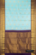 Sky Blue Dual Tone Kanchipuram Silk Saree with Zari Butta on the body and Zari Border.  displayed on a mannequin