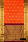 Orange Dual Tone Kanchipuram Silk Saree with Zari Butta on the body and Zari Border.  displayed on a mannequin