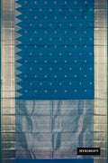 Peacock Blue Dual Tone Kanchipuram Silk Saree with Zari Butta on the body and Temple Border.  displayed on a mannequin