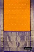 Mustard Dual Tone Kanchipuram Silk Saree with Zari Butta on the body and Zari Border.  displayed on a mannequin