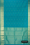 Peacock Blue Dual Tone Kanchipuram Silk Saree with Zari Butta on the body and Zari Border.  displayed on a mannequin