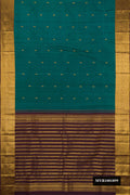 Green Dual Tone Kanchipuram Silk Saree with Zari Butta on the body and Zari Border.  displayed on a mannequin