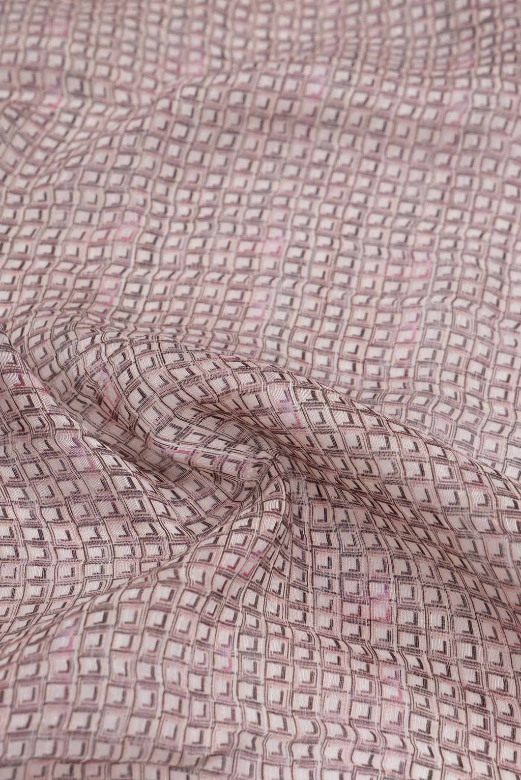 Close up of Golden Peach Dual Tone Linen Saree with Printed design on the body and Zari Border.  displaying folds