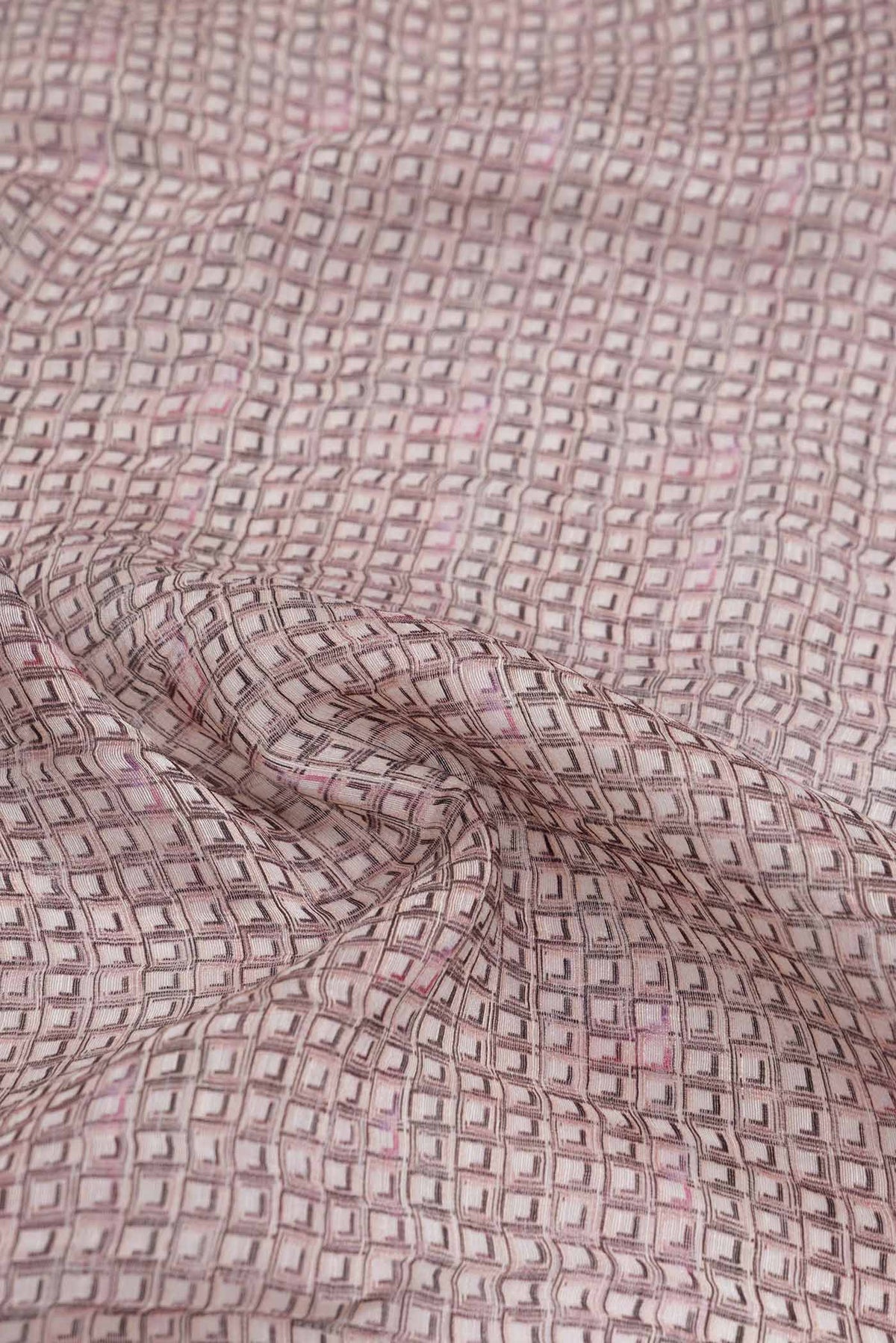 Close up of Golden Peach Dual Tone Linen Saree with Printed design on the body and Zari Border.  displaying folds