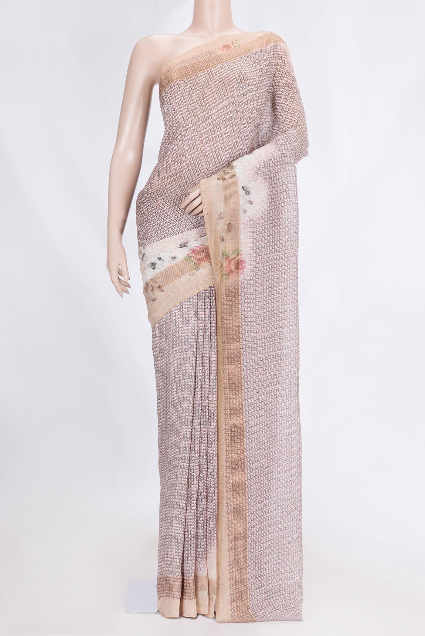 Golden Peach Dual Tone Linen Saree with Printed design on the body and Zari Border.  displayed on a mannequin