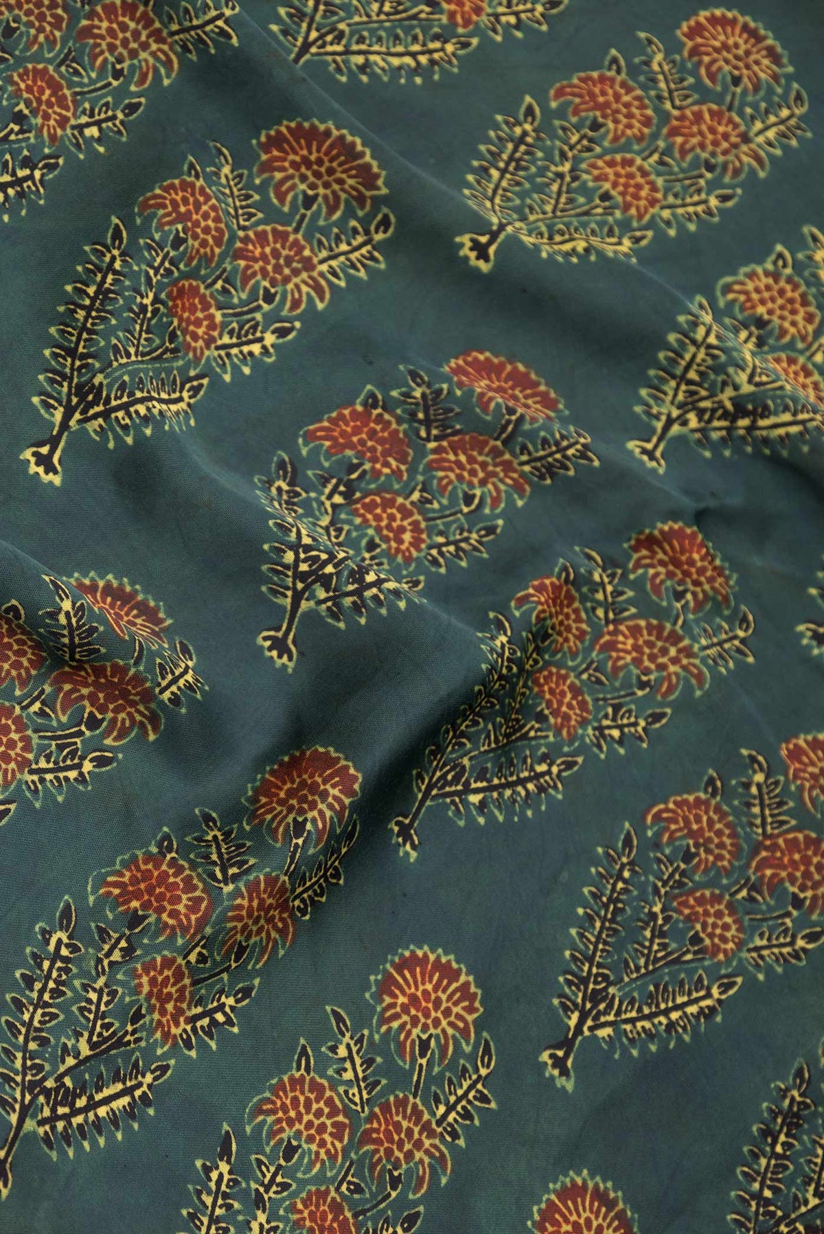 Close up of Green Dual Tone Linen Saree with Printed design on the body and Zari Border displaying folds