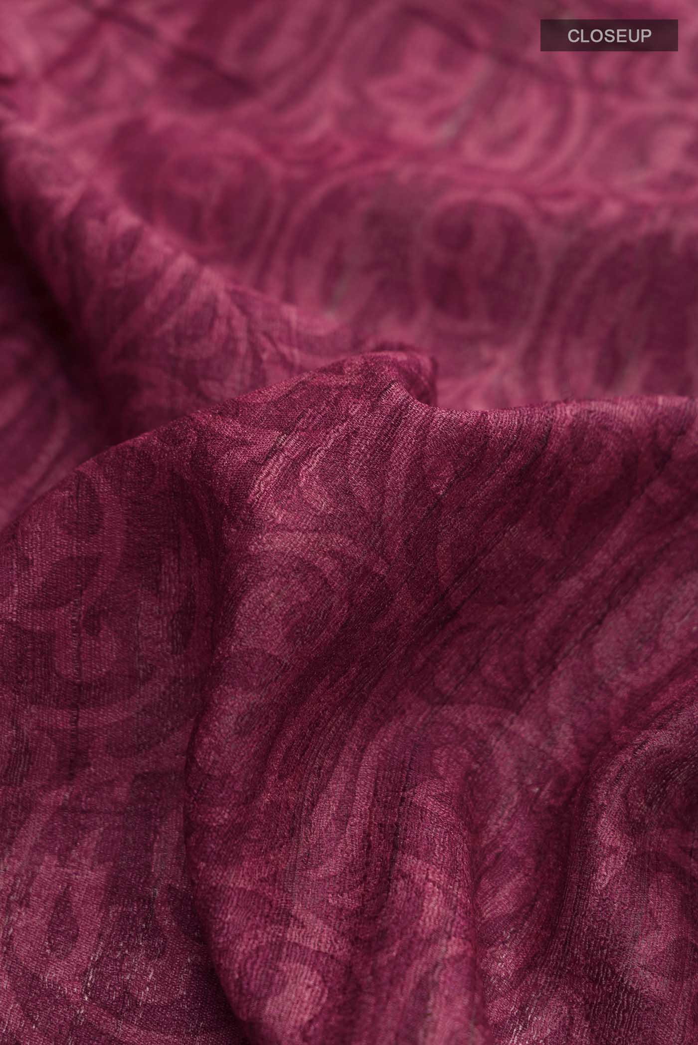 Close up of Maroon Tussar Silk Saree with Printed design on the body and Printed Border displaying folds
