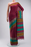 Maroon Tussar Silk Saree with Printed design on the body and Printed Border displayed on a mannequin