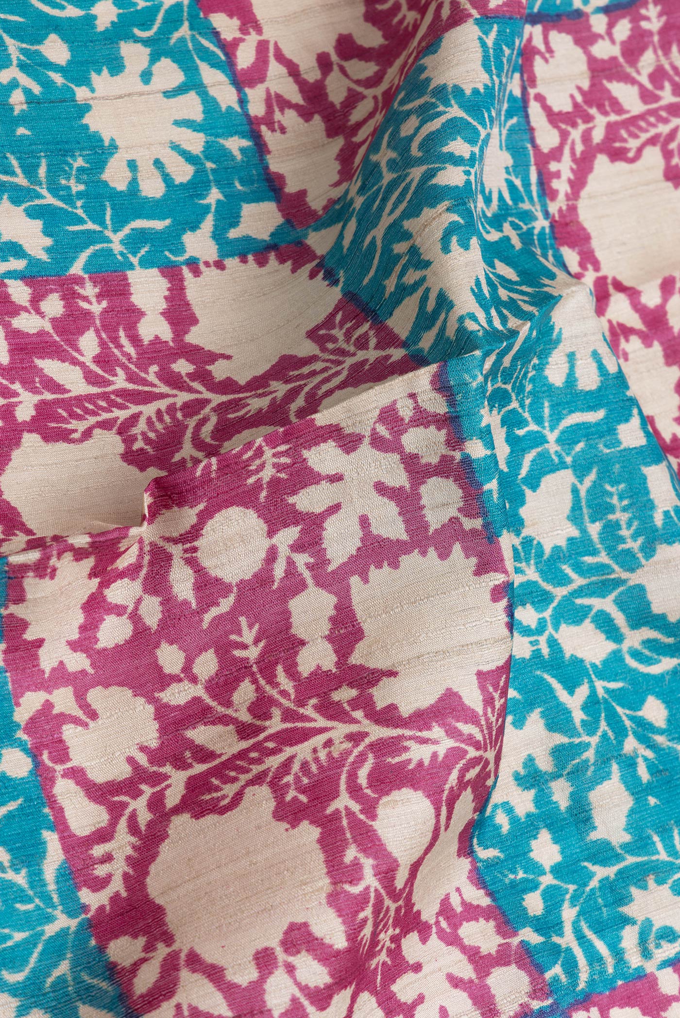 Close up of Pink and Sky Blue Color Tussar Silk Saree with Printed design on the body and Zari Border.  displaying folds