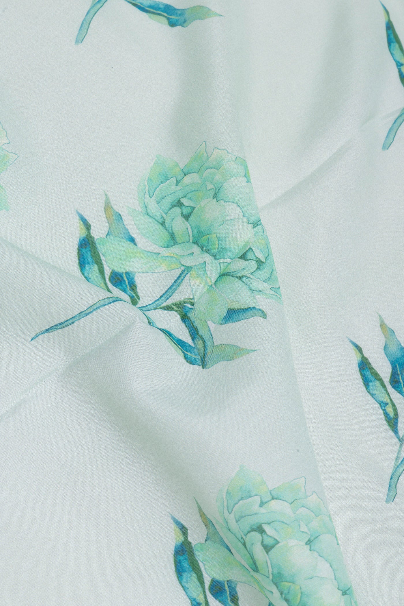 Close up of Light Blue Chanderi Silk Cotton Saree with Floral Print on the body and Fancy Border.  displaying folds