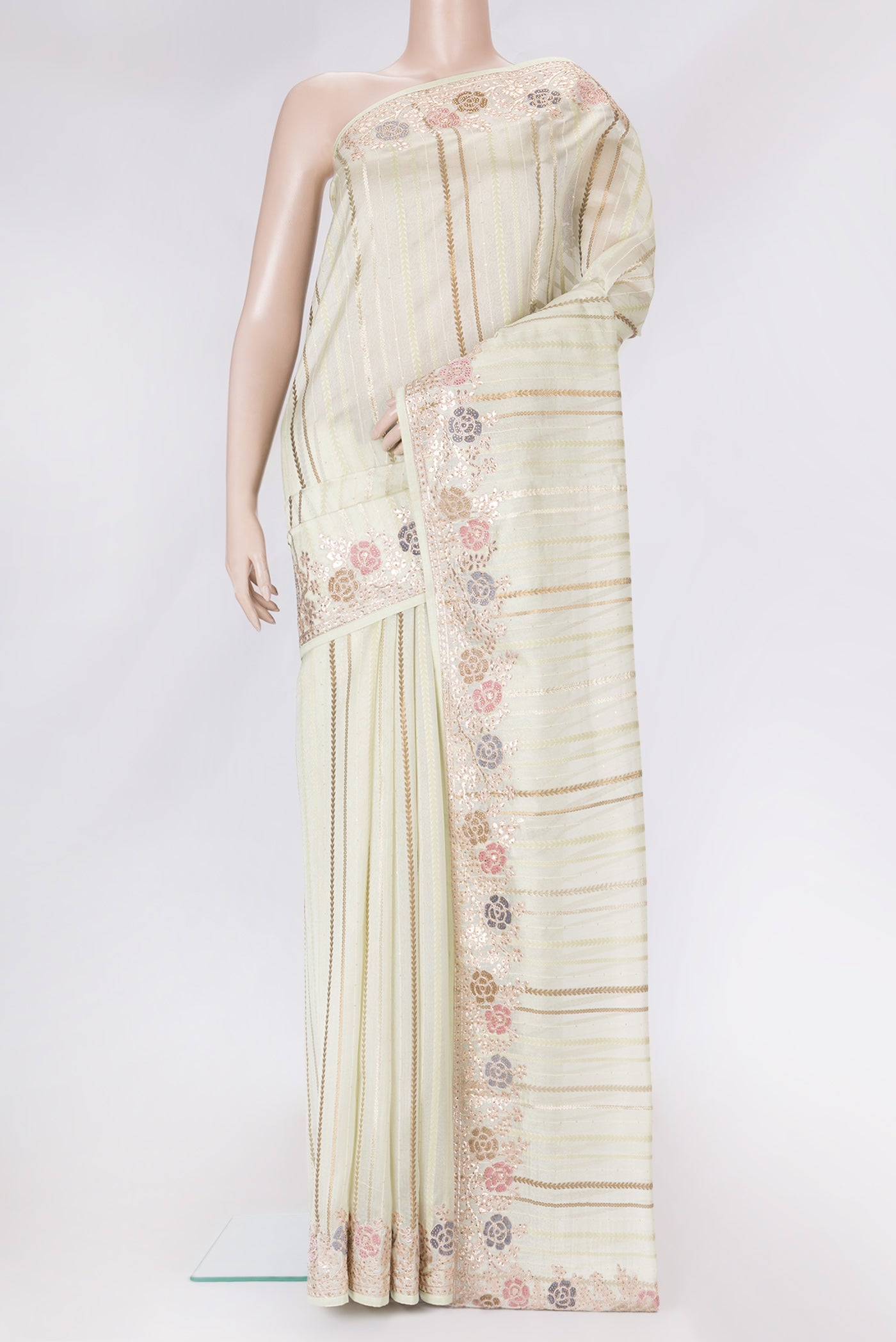 Pista Green Dual Tone Organza Silk Saree with Stripes on the body and Fancy Border.  displayed on a mannequin