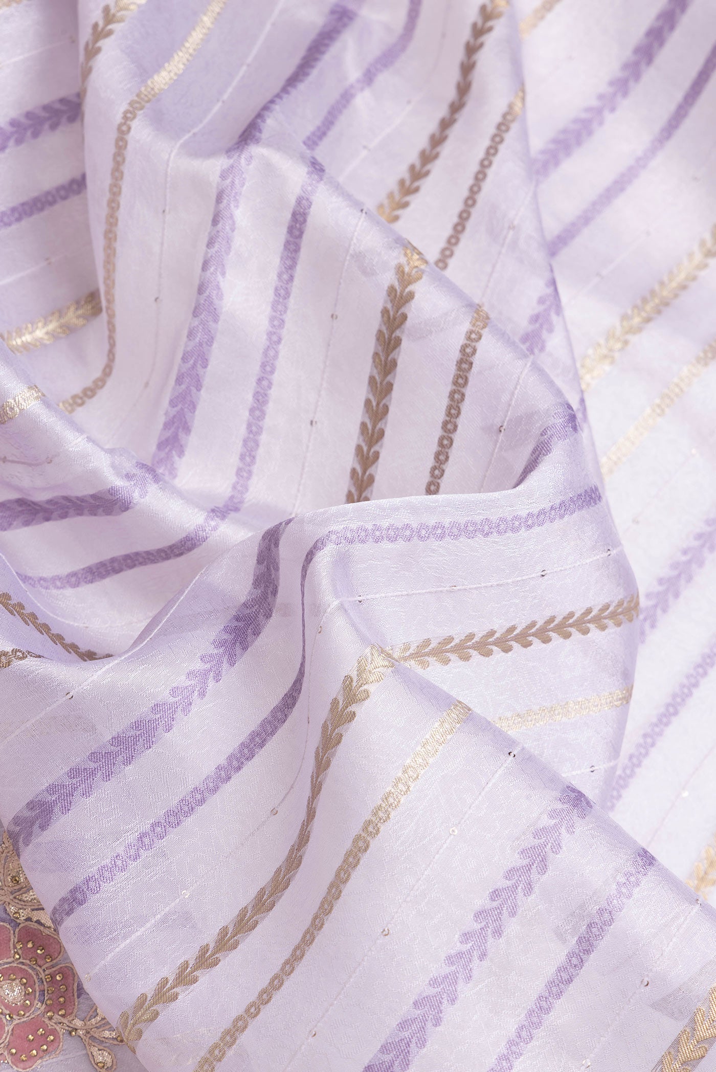 Close up of Lavender Dual Tone Organza Silk Saree with Stripes on the body and Fancy Border.  displaying folds