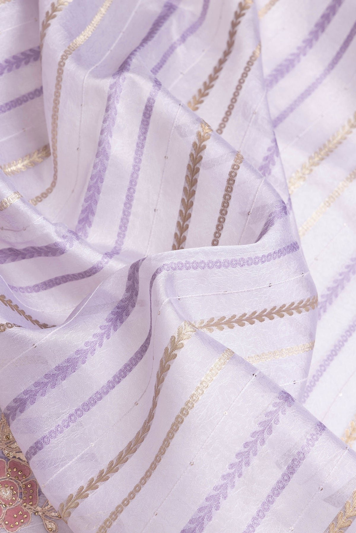 Close up of Lavender Dual Tone Organza Silk Saree with Stripes on the body and Fancy Border.  displaying folds
