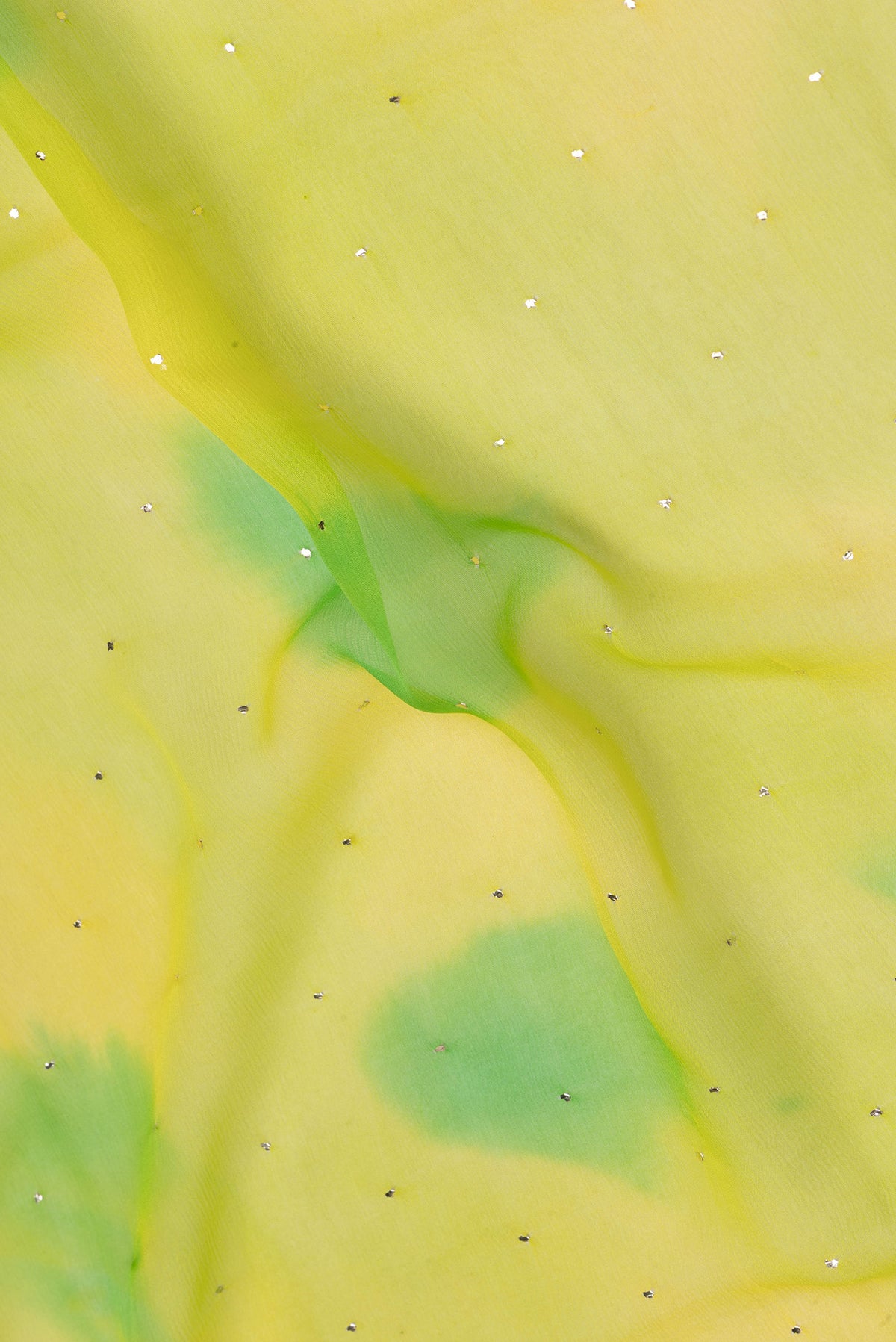 Close up of Parrot Green Dual Tone Mysore Chiffon Saree with Embroidery on the body and Zari Border.  displaying folds