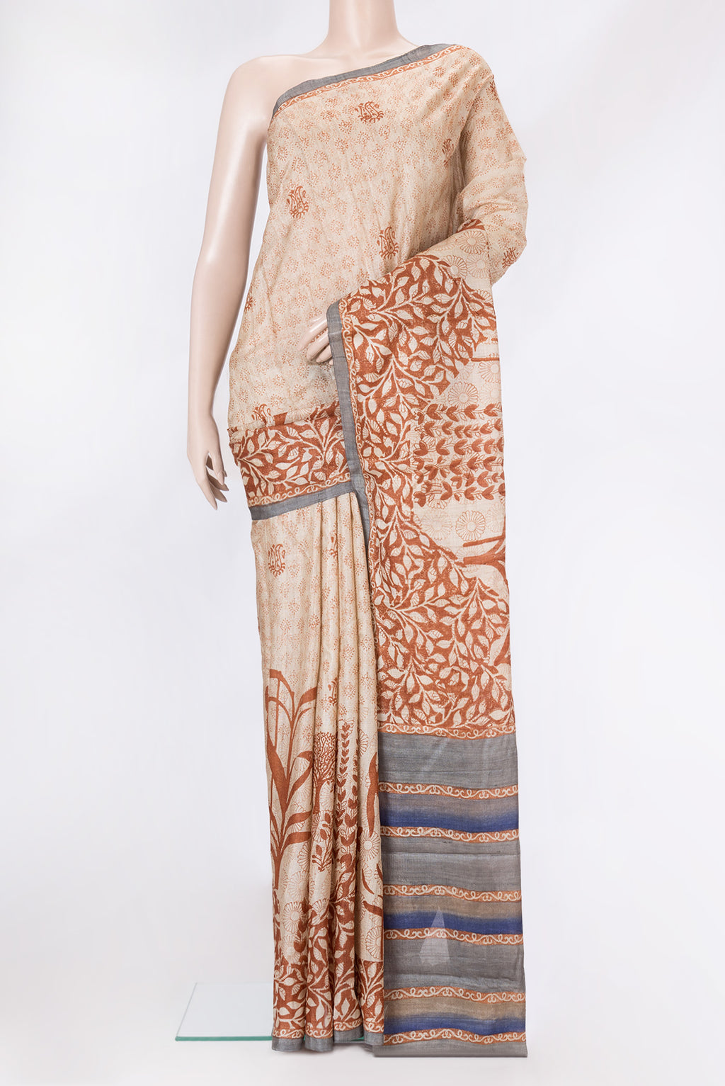 Beige Tussar Silk Saree with Printed design on the body and Printed Border.  displayed on a mannequin