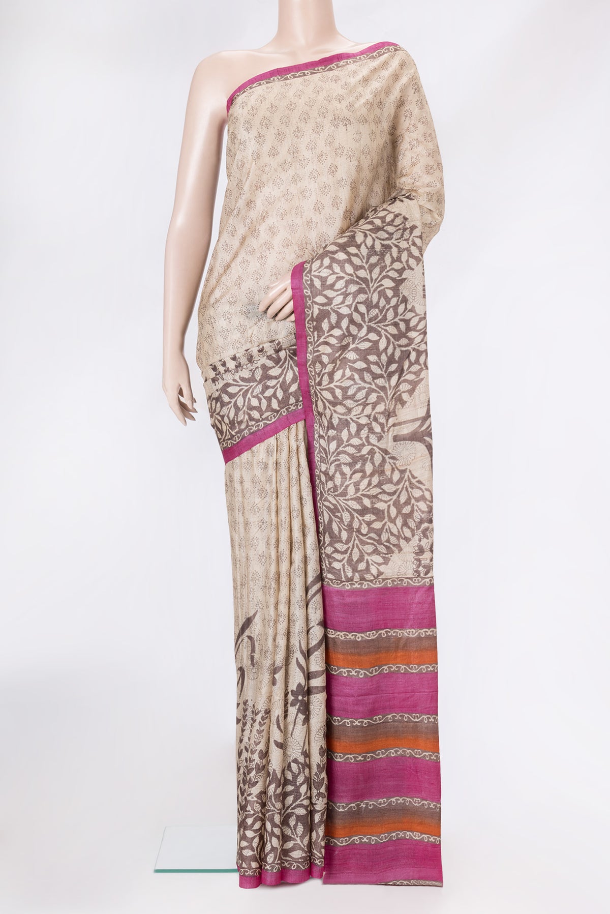 Beige Tussar Silk Saree with Printed design on the body and Fancy Border.  displayed on a mannequin