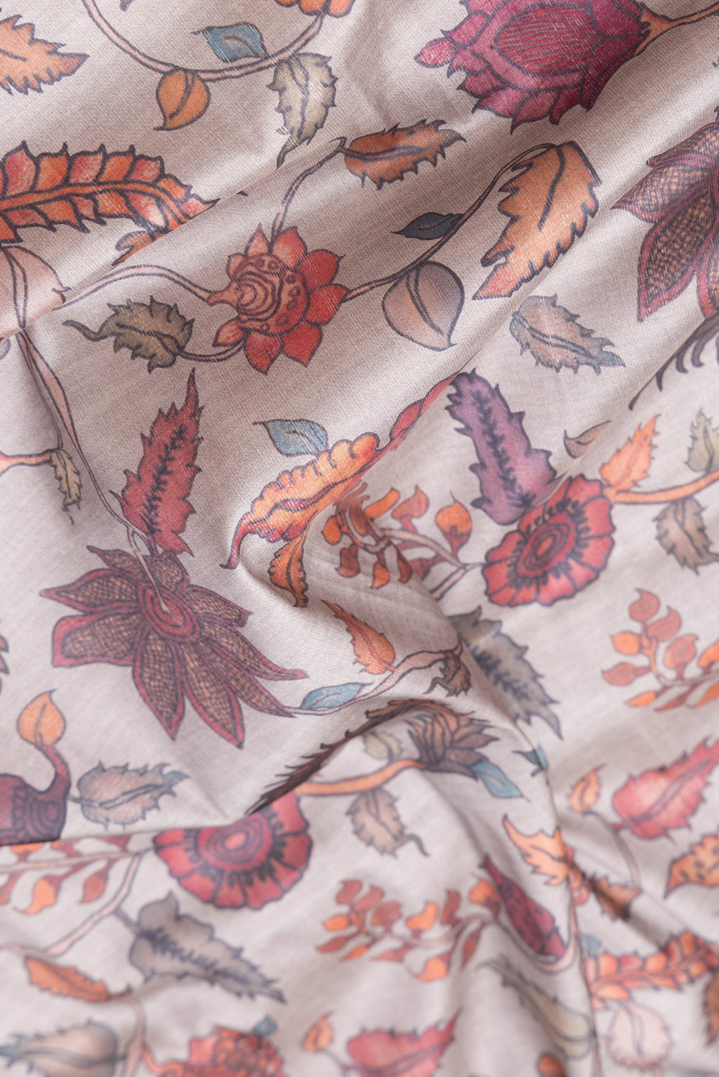 Close up of Grey Dual Tone Tussar Silk Saree with kalamkari Print on the body and Paithani Border.  displaying folds