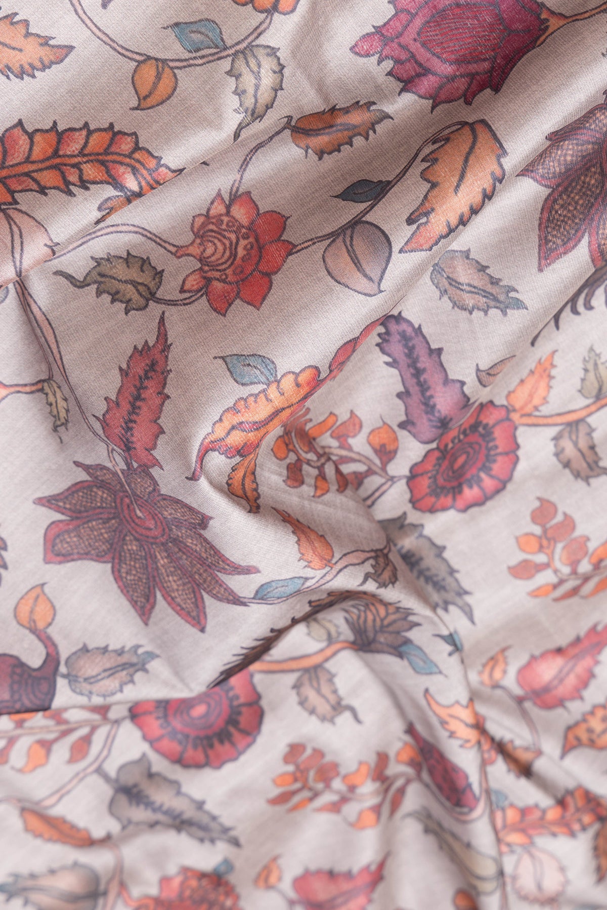 Close up of Grey Dual Tone Tussar Silk Saree with kalamkari Print on the body and Paithani Border.  displaying folds