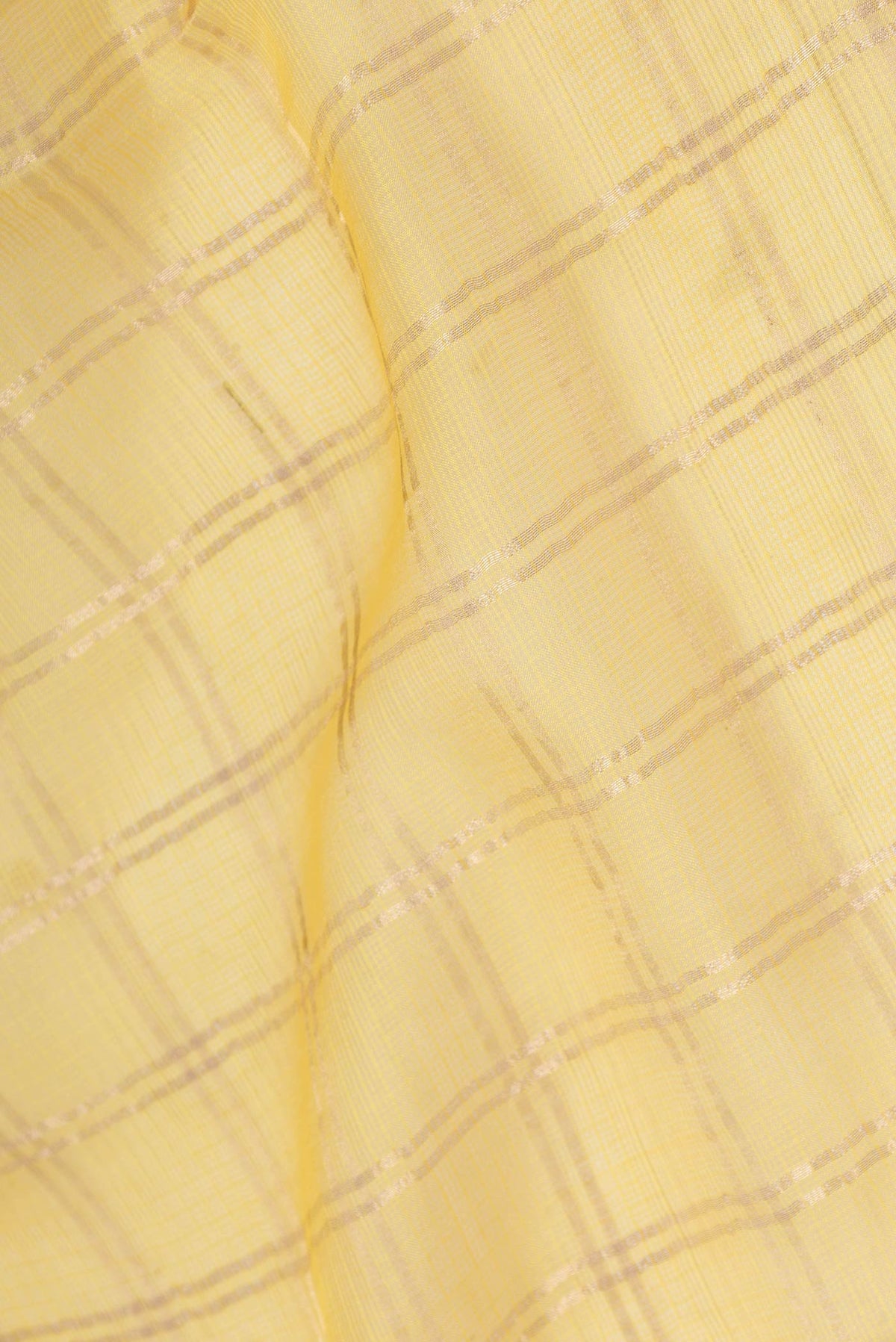 Close up of Yellow Dual Tone Kota Silk Saree with Checked design on the body and Zari Border displaying folds