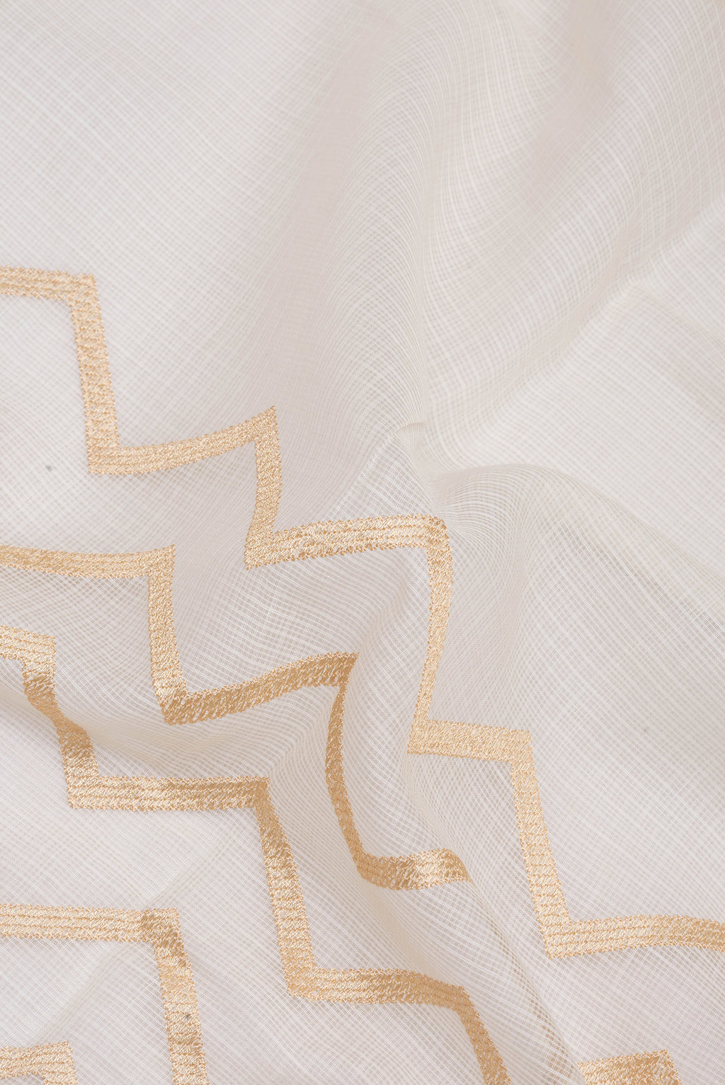 Close up of Off White Kota Silk Saree with Embroidery on the body and Embroidery Border.  displaying folds