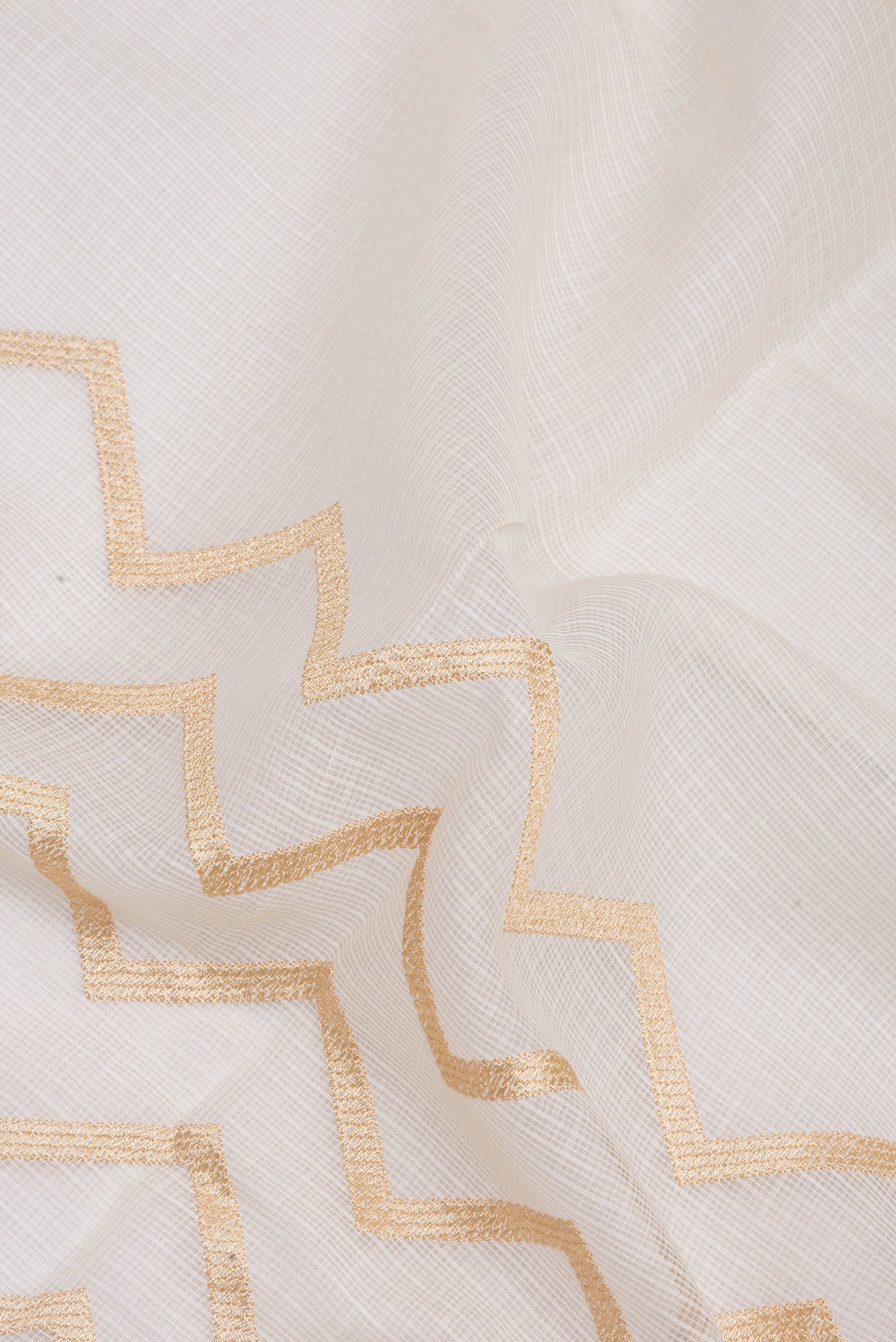 Close up of Off White Kota Silk Saree with Embroidery on the body and Embroidery Border.  displaying folds
