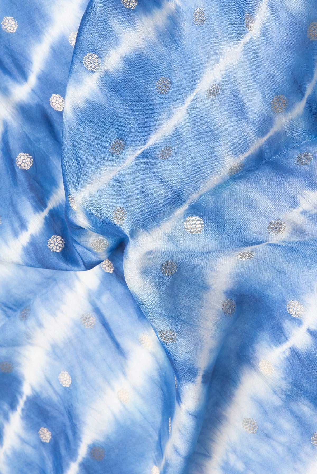 Close up of Peacock Blue Dual Tone Tussar Silk Saree with Zari Butta on the body and Embroidery Border.  displaying folds