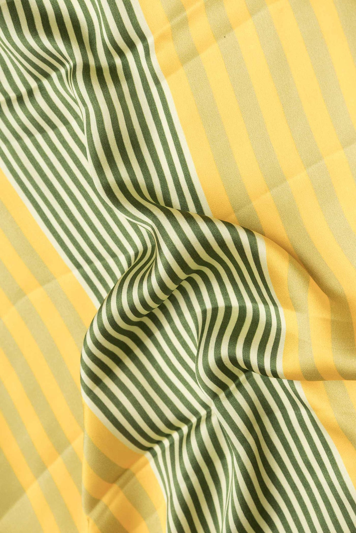 Close up of Green Satin Silk Saree with Geometric Print on the body and Zari Border displaying folds