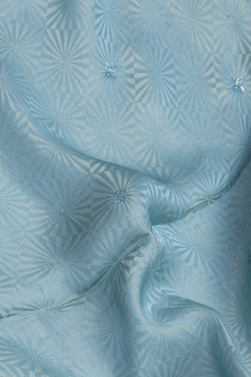 Close up of Blue Dual Tone Georgette Saree with Embroidery on the body and Embroidery Border.  displaying folds