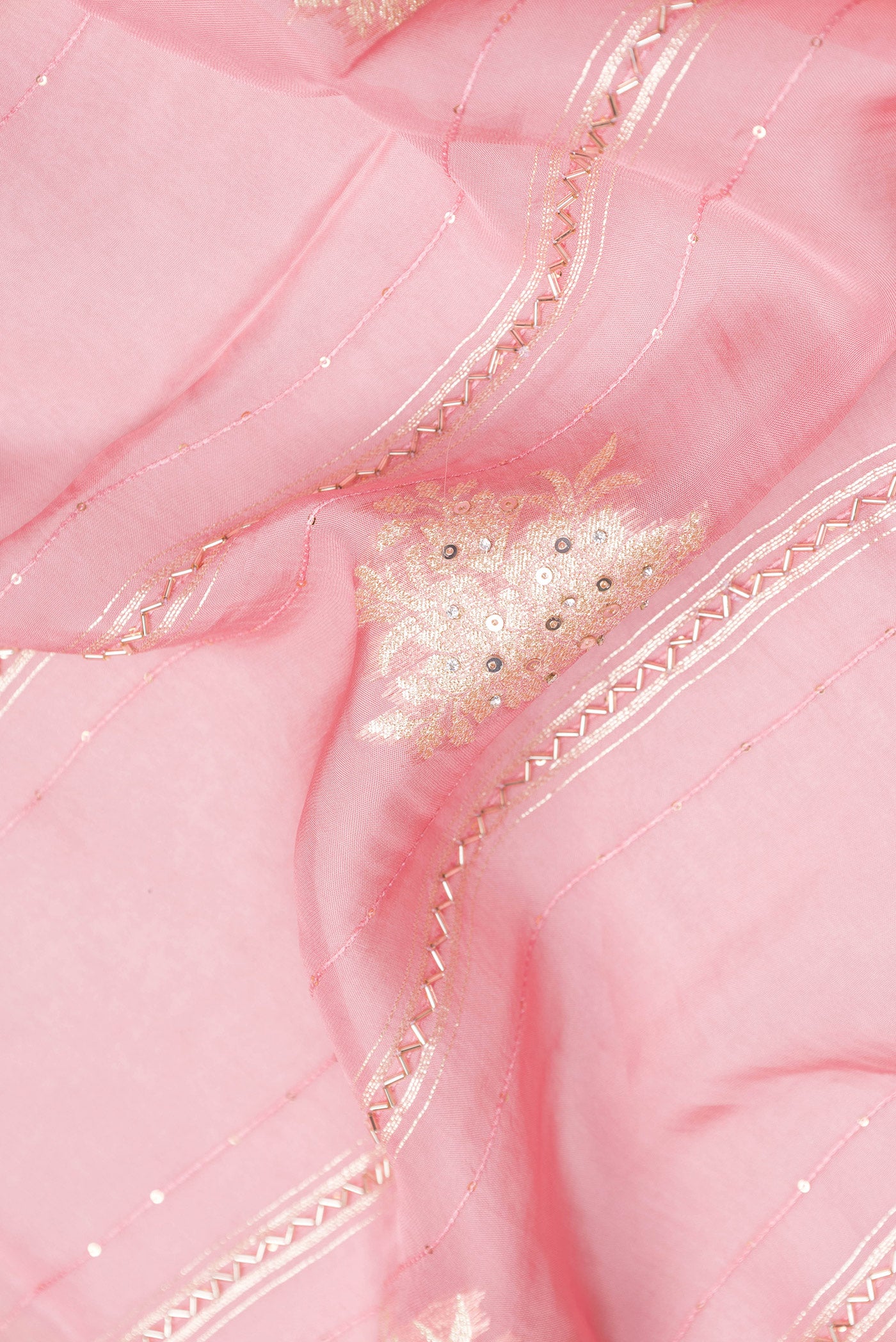 Close up of Pink Georgette Saree with Embroidery on the body and Embroidery Border.  displaying folds