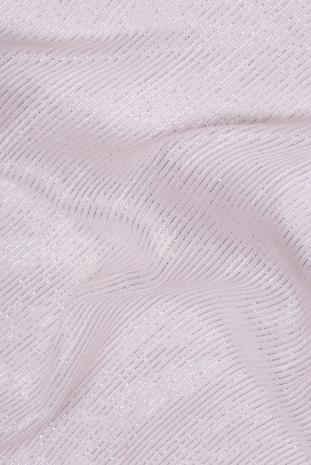 Close up of Rose Gold Dual Tone Georgette Saree with Embroidery on the body and Sequin Border.  displaying folds