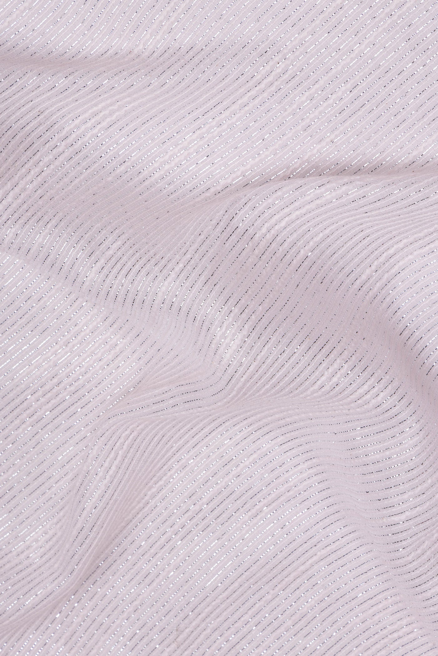 Close up of Rose Gold Dual Tone Georgette Saree with Embroidery on the body and Sequin Border.  displaying folds