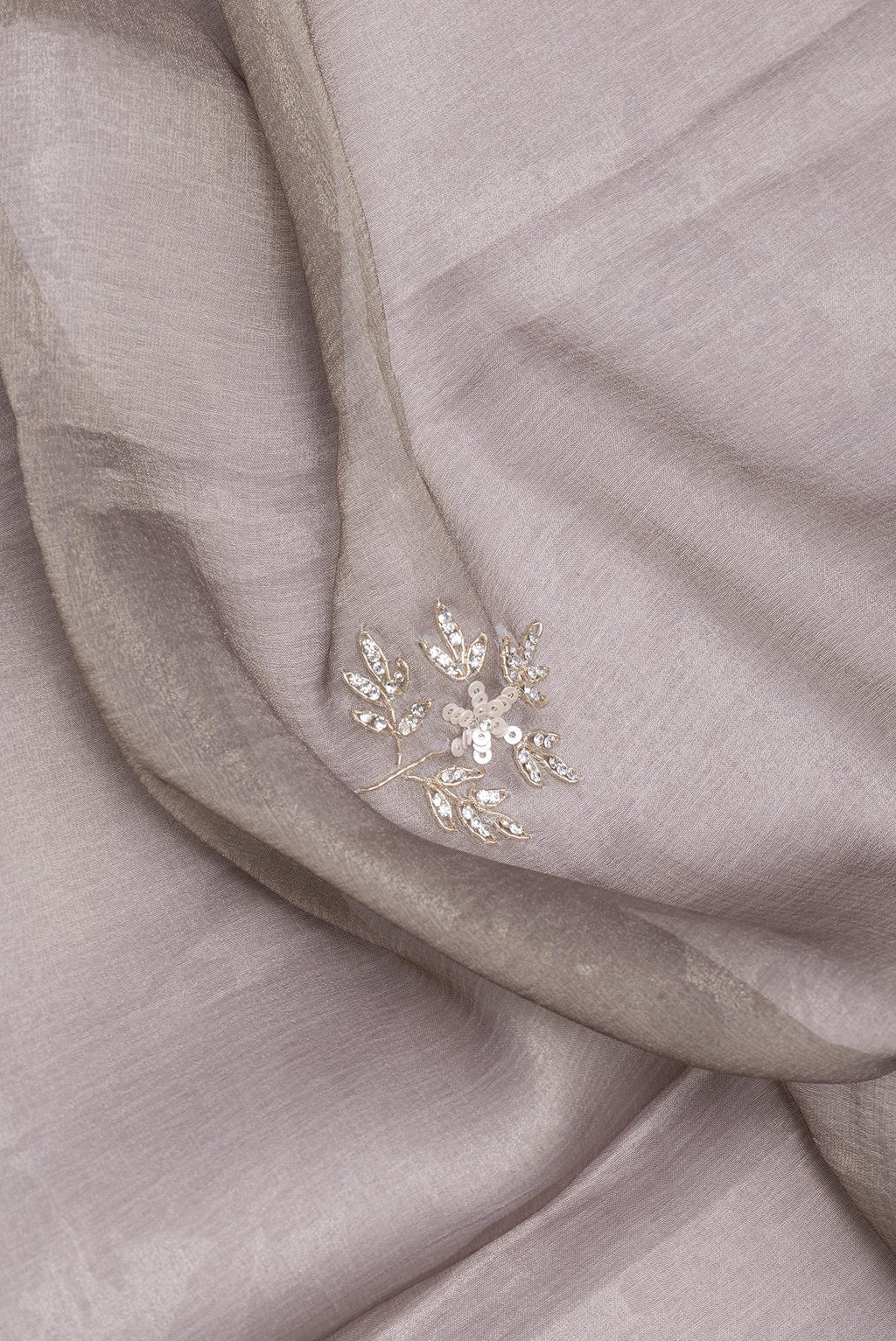 Close up of Grey Georgette Saree with Embroidery on the body and Embroidery Border.  displaying folds
