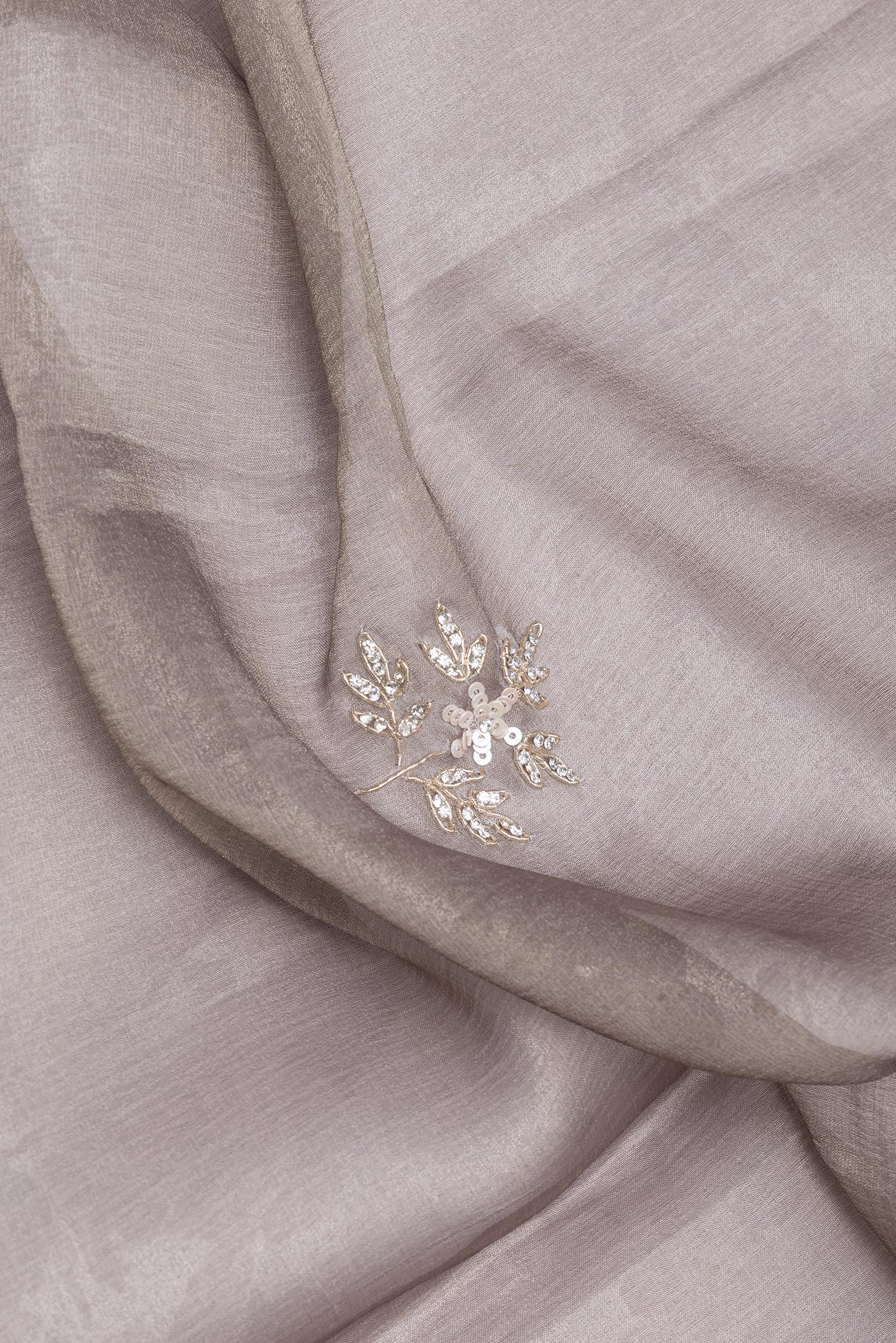 Close up of Grey Georgette Saree with Embroidery on the body and Embroidery Border.  displaying folds