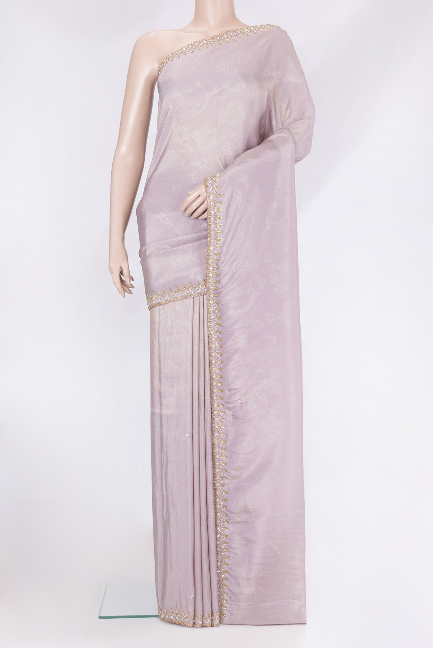 Lilac Crepe Saree with Embroidery on the body and Embroidery Border.  displayed on a mannequin