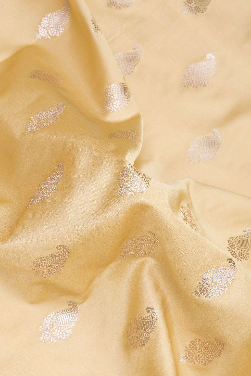 Close up of Sandal Blended Banarasi Silk Saree with Zari Butta on the body and Zari Border.  displaying folds