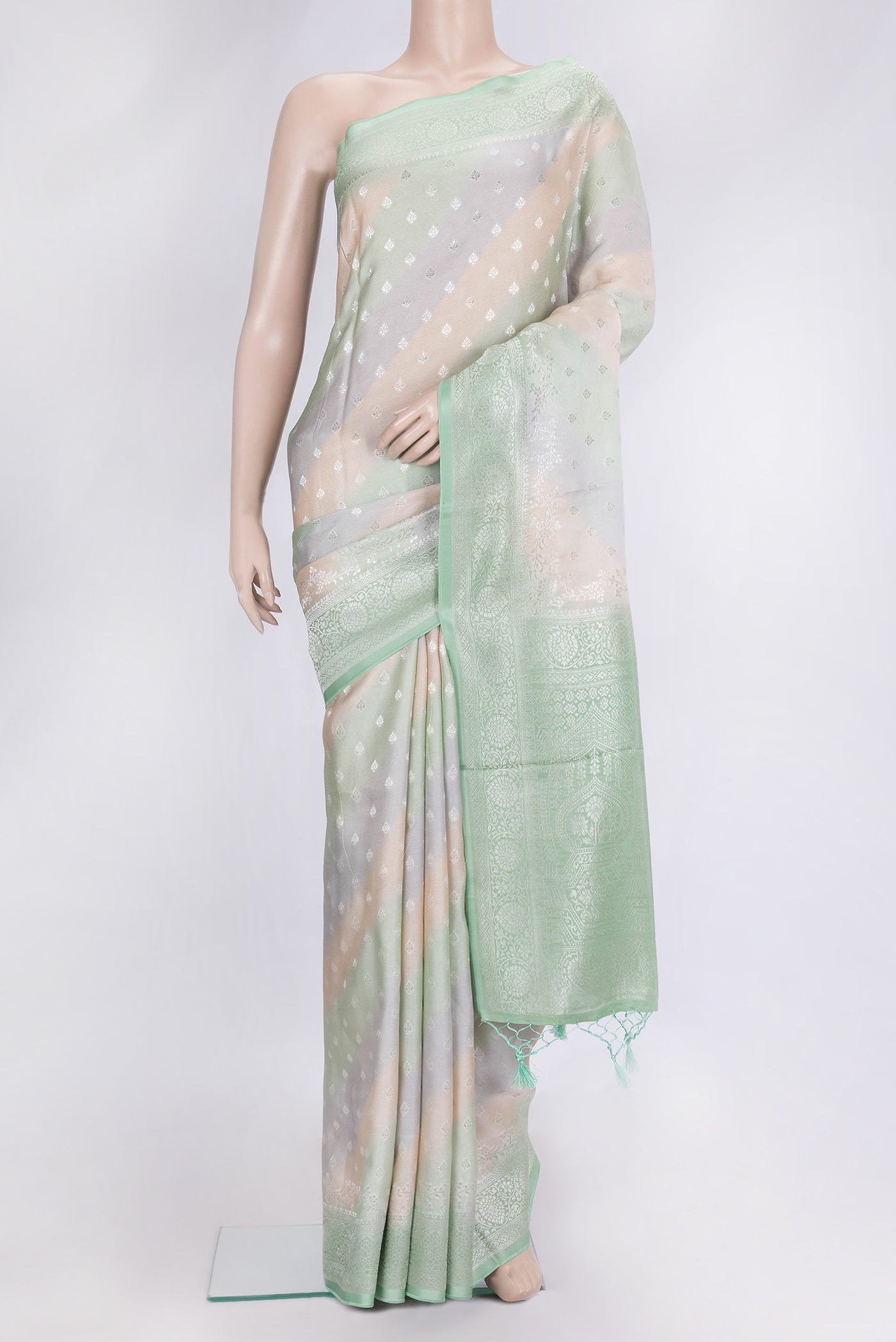 Green and Grey Color Organza Silk Saree with Zari Butta on the body and Zari Border.  displayed on a mannequin