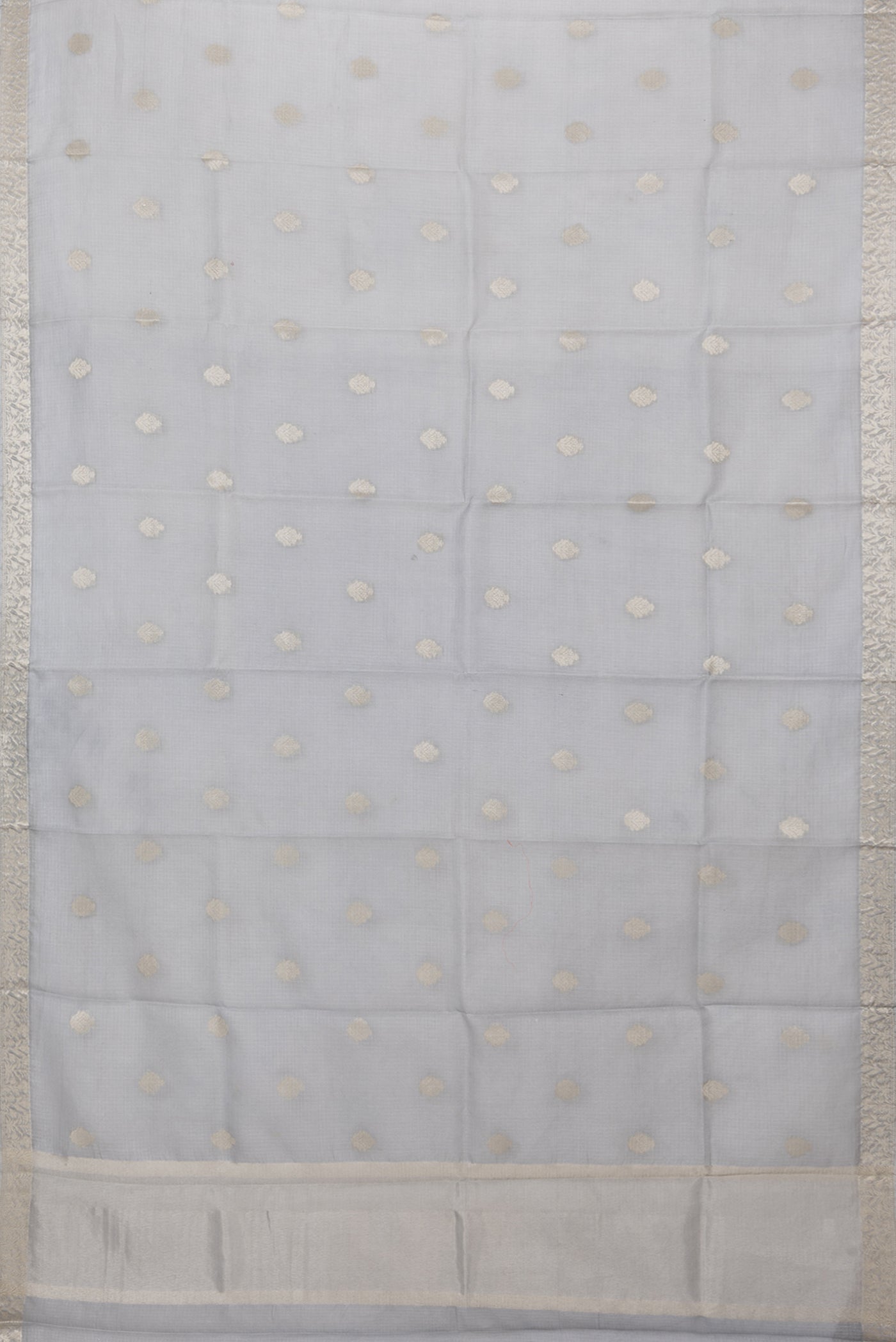 Flat view of Grey Kota Silk Saree with Zari Butta on the body and Zari Border. 