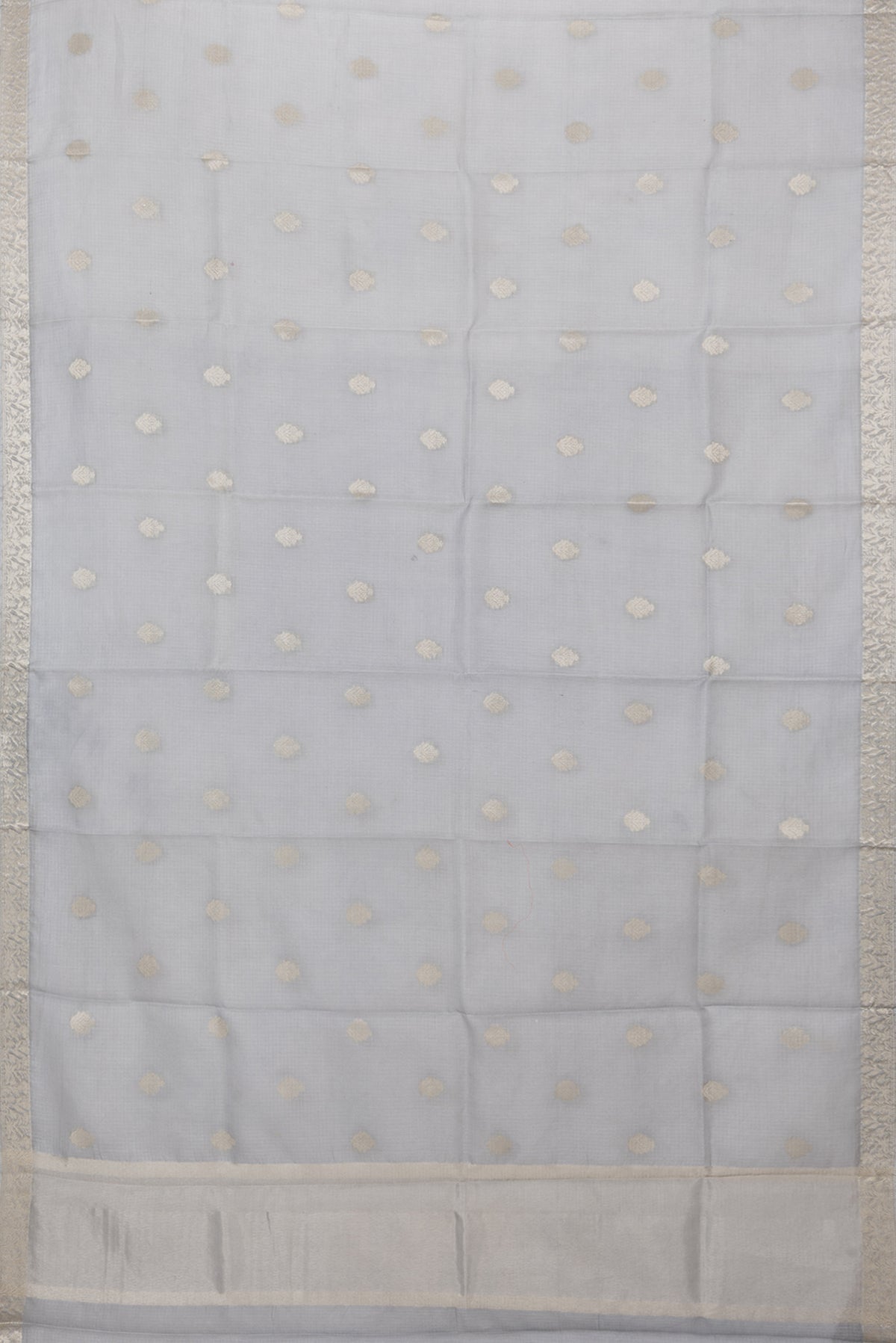 Flat view of Grey Kota Silk Saree with Zari Butta on the body and Zari Border. 