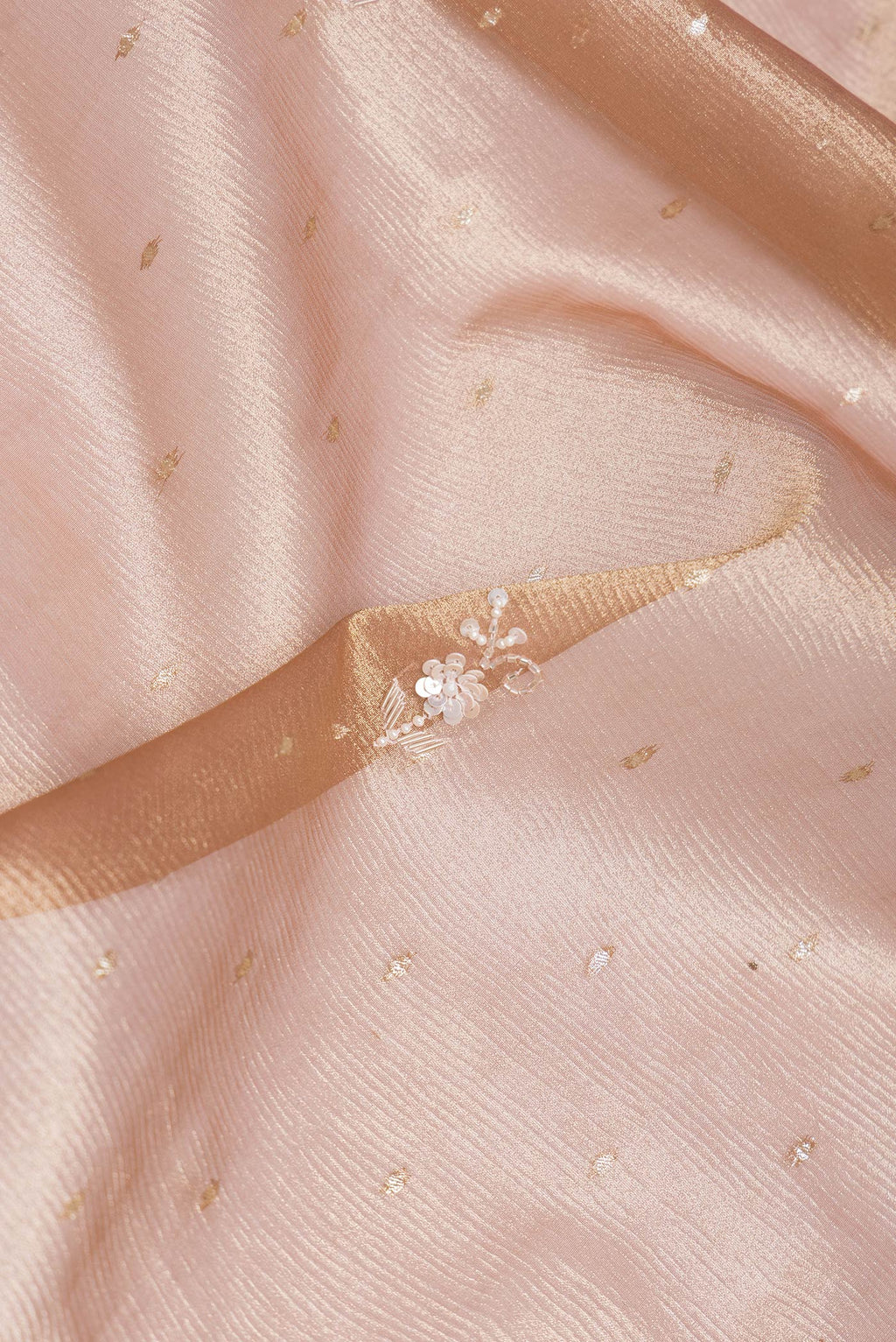 Close up of Rose Gold Dual Tone Organza Silk Saree with Embroidery on the body and Embroidery Border.  displaying folds