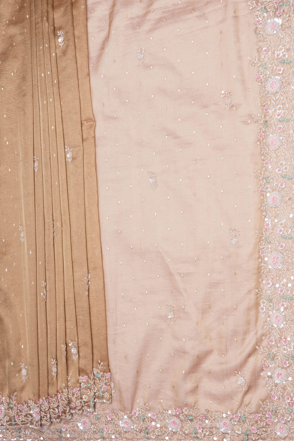 Pleats and pallu of Rose Gold Dual Tone Organza Silk Saree with Embroidery on the body and Embroidery Border. 