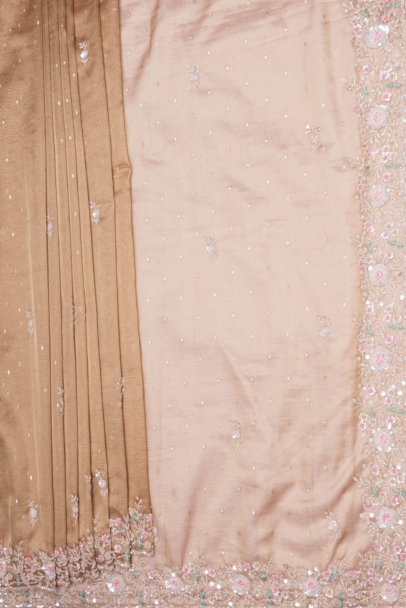 Pleats and pallu of Rose Gold Dual Tone Organza Silk Saree with Embroidery on the body and Embroidery Border. 