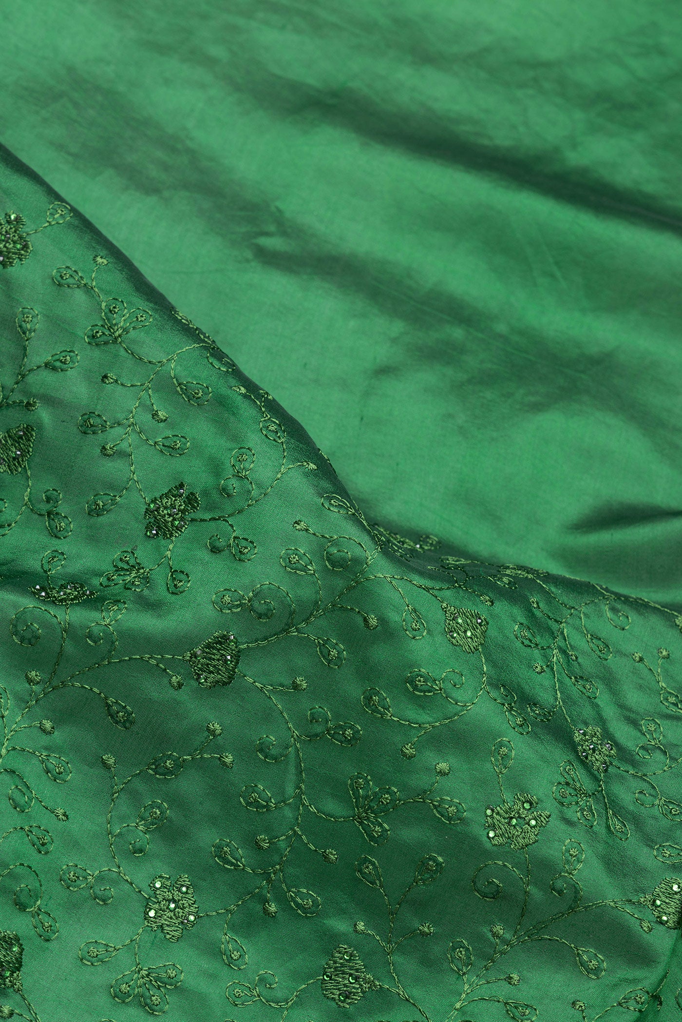 Close up of Bottle Green Dual Tone Tussar Silk Saree with Embroidery on the body and Embroidery Border.  displaying folds