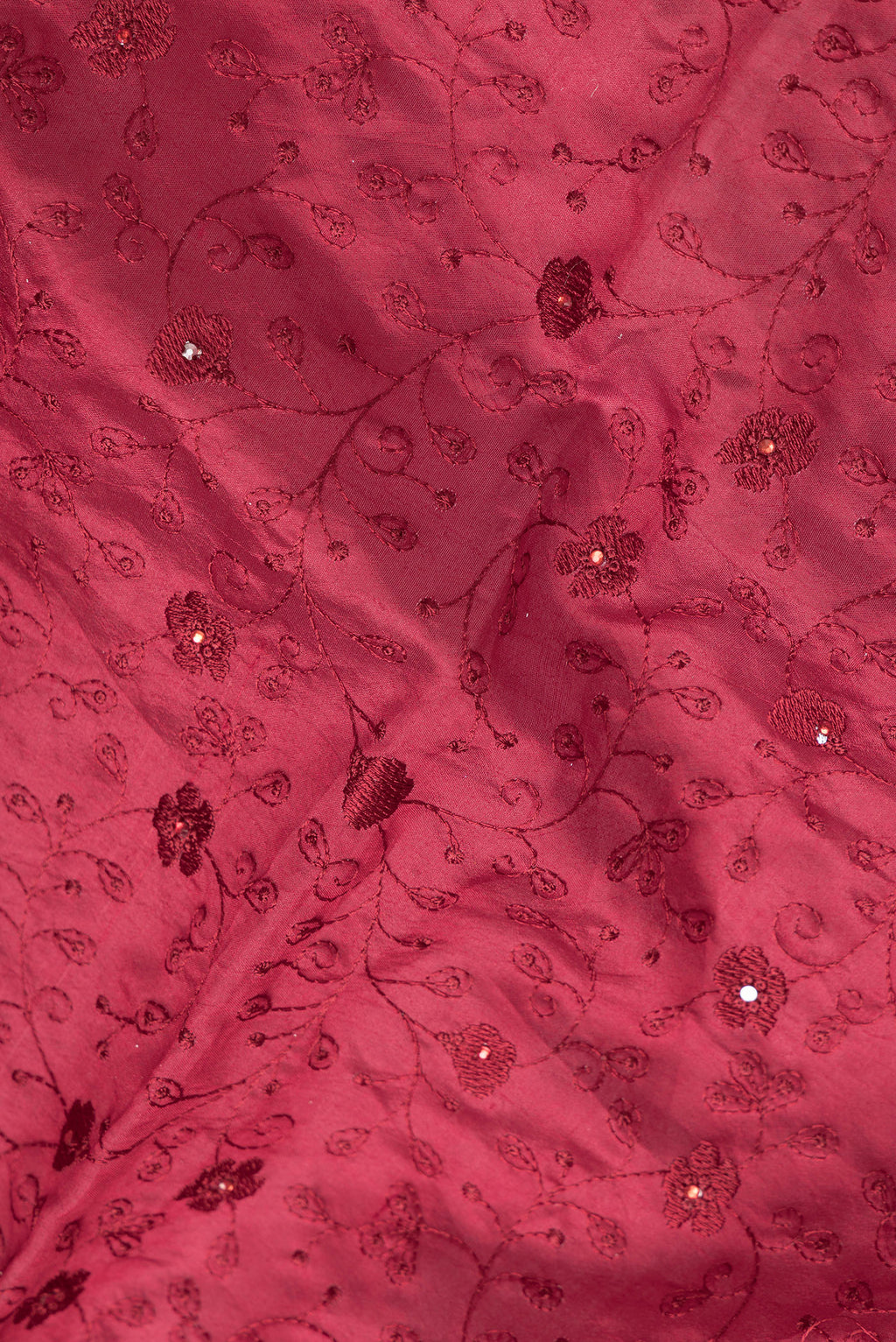 Close up of Maroon Dual Tone Tussar Silk Saree with Embroidery on the body and Embroidery Border.  displaying folds