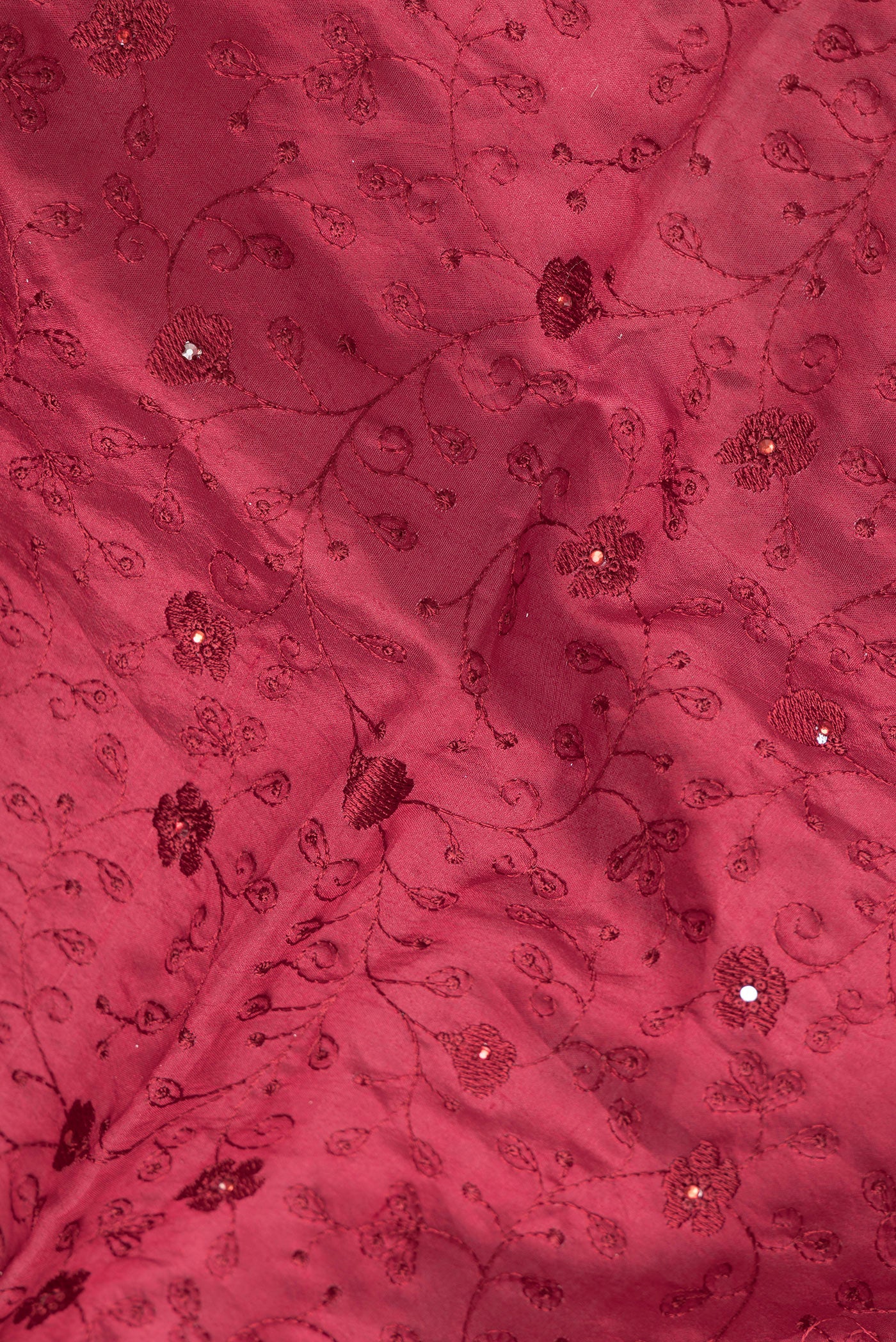 Close up of Maroon Dual Tone Tussar Silk Saree with Embroidery on the body and Embroidery Border.  displaying folds