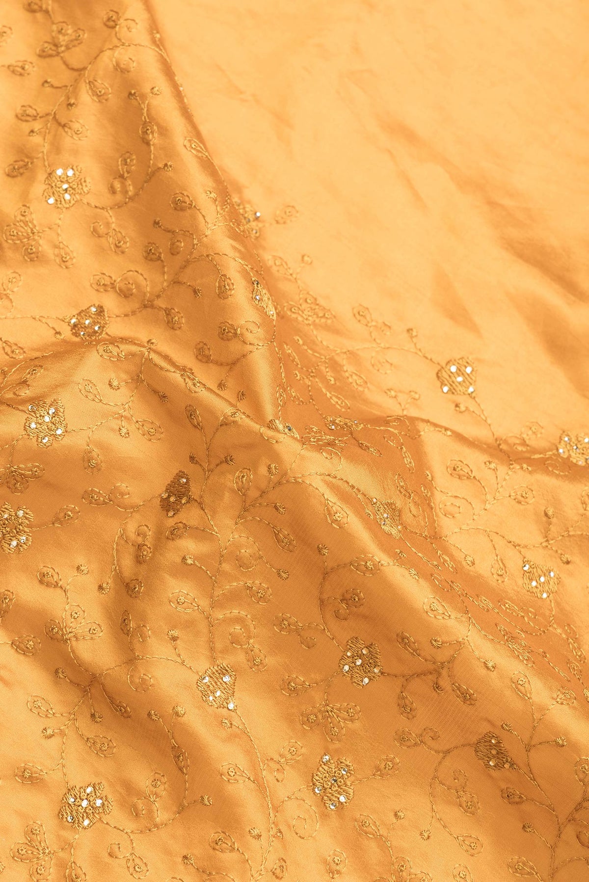 Close up of Mustard Dual Tone Tussar Silk Saree with Embroidery on the body and Embroidery Border.  displaying folds
