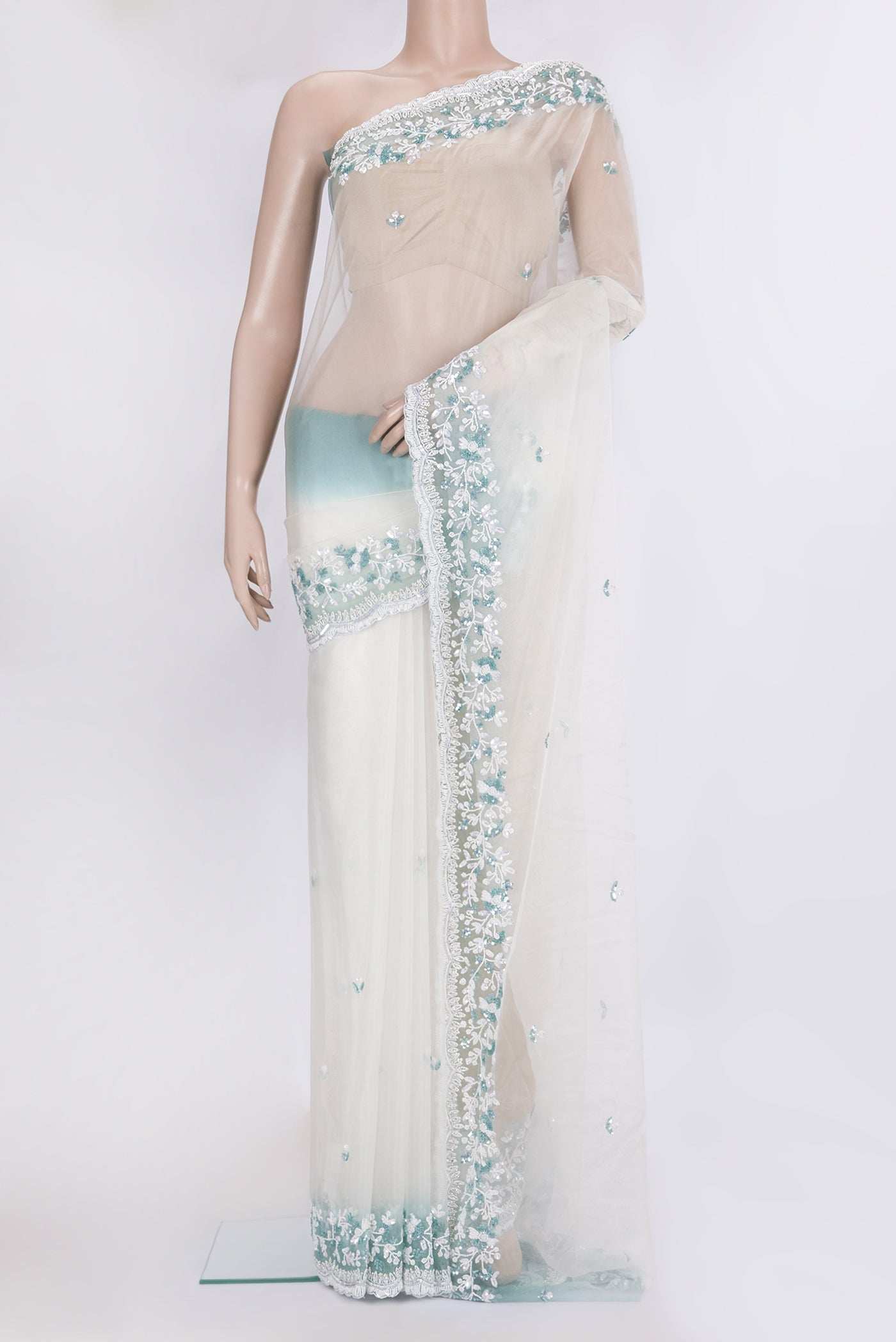 Off White Dual Tone Organza Silk Saree with Embroidery on the body and Embroidery Border.  displayed on a mannequin