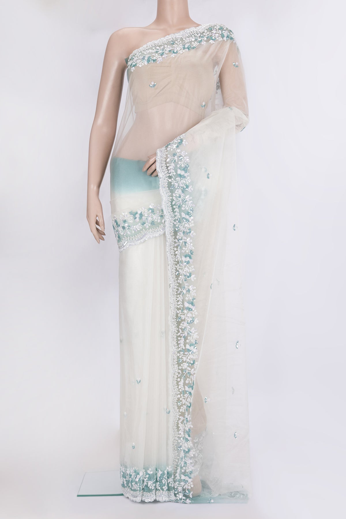 Off White Dual Tone Organza Silk Saree with Embroidery on the body and Embroidery Border.  displayed on a mannequin