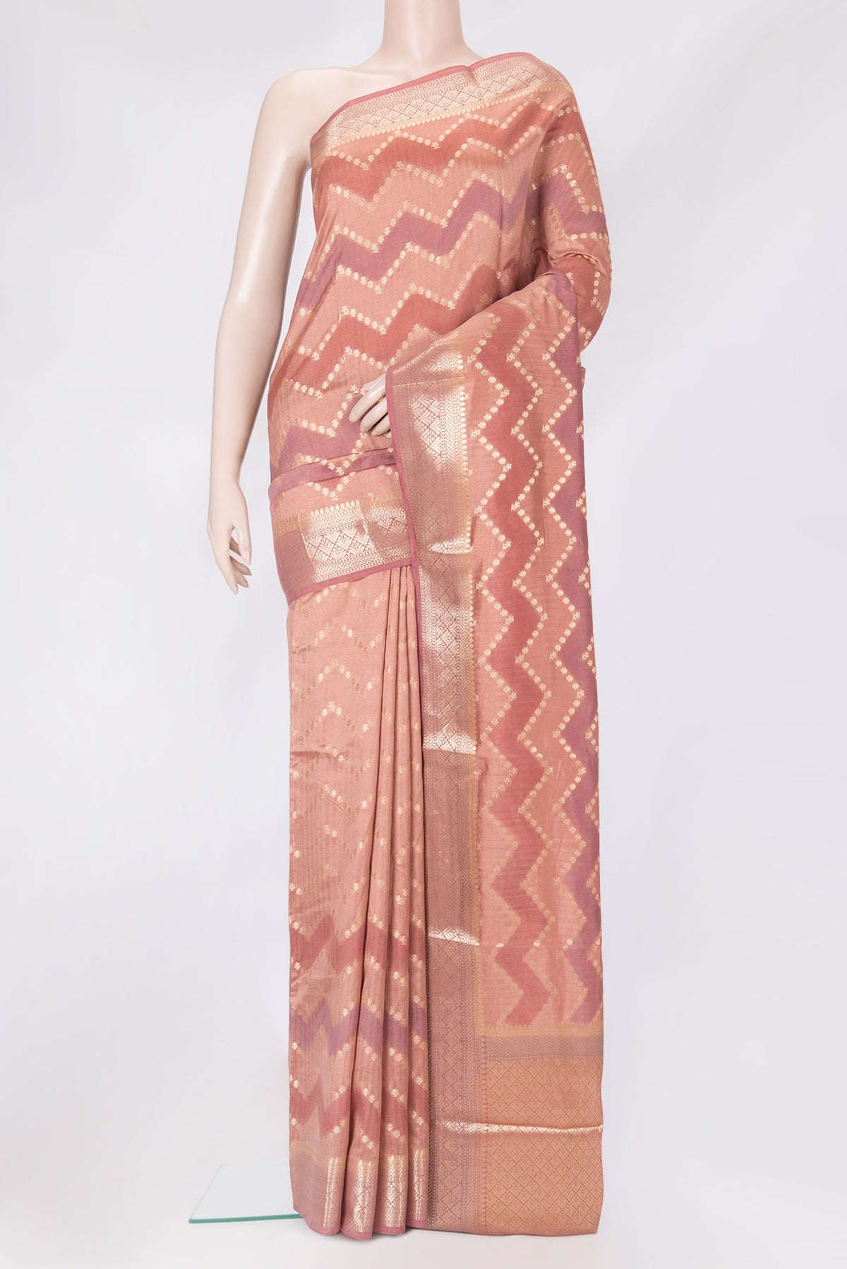 Peach Tussar Silk Saree with Zari Butta on the body and Zari Border.  displayed on a mannequin